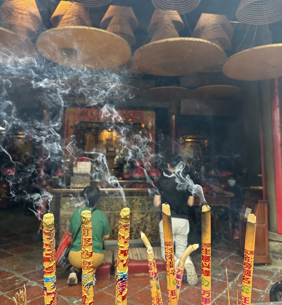 People Praying and lighting Incense sticks at A-ma Temple, Macao. Photo by Pooja Amritkar