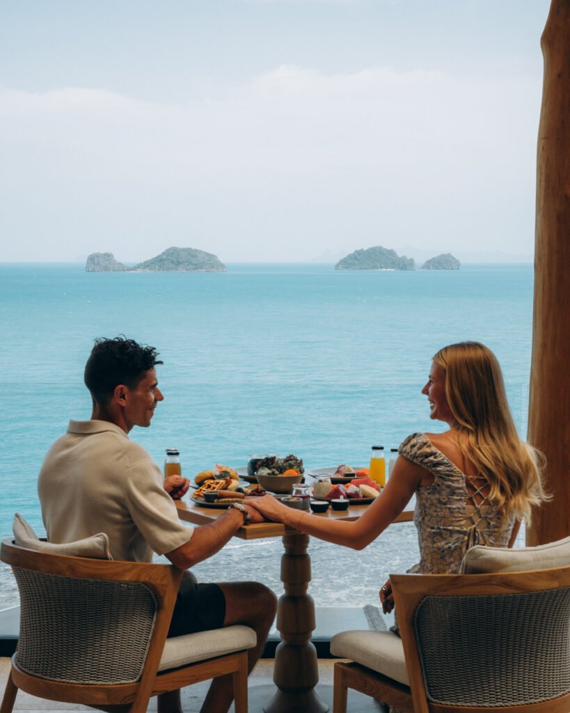 Couple enjoying breakfast with ocean view. Conrad Koh Samui Unveils AOW THAI, A Thoughtful Culinary Experience Rooted in Sustainability