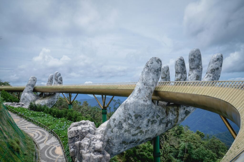 Golden bridge held by giant hands. Golden Bridge. By Simon Van Rompaey