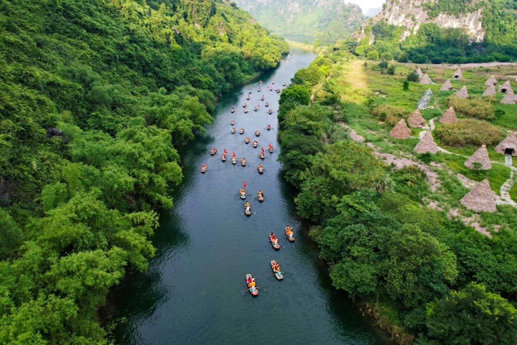 Boats on a serene river landscape. Ninh Binh. By Hoang Vu Tuyen